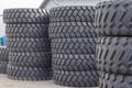 Large rubber tires for trucks lying on the street. Many close-up tires with a large tread are lying Royalty Free Stock Photo