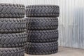 Large rubber tires for trucks lying on the street. Many new tires close-up with a large tread are Royalty Free Stock Photo