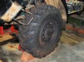 Large rubber truck wheel stands on an anti-slip sole