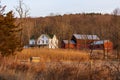 Large rural country home and red barn in dry winter landscape Royalty Free Stock Photo