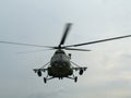Large Russian military helicopter flying against the gray sky