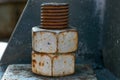 A large rusted bolt with screw. Part of a huge metal construction.