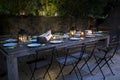 Large rustic table prepared for a outside dinner at night Royalty Free Stock Photo