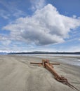 Large rusty anchor on beach