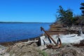 A large rusty anchor on the shore of a saltwater bay in Nova Scotia Royalty Free Stock Photo