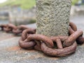 Large rusty chain on the quayside