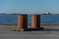 Large rusty iron bollards at a dock