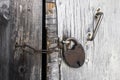 Large rusty lock is on the wooden barn door