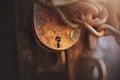 A large rusty padlock and a rusty metal chain close the old door. Secret Royalty Free Stock Photo