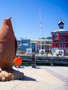 Large rusty penguin statue standing next to the bridge crossing at the Waterfront in Cape Town.