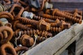 Large rusty screws in a wooden box