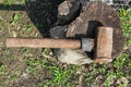 A large rusty sledgehammer on a wooden stump Royalty Free Stock Photo