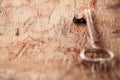 Large rusty vintage metal key on old wooden background