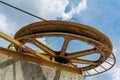 Large rusty wheel rope pulley