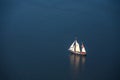 A large sailboat goes to sea under sail. View from above.