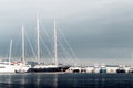 Large sailing yacht among the smaller yachts at the marina