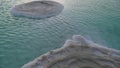 Large Salt accumulated on the shore of the Dead sea. Deposits of mineral salts, typical landscape of the Dead Sea. Salt on beach