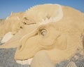 Large sand sculpture statue of a dinosaur Royalty Free Stock Photo