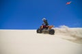 Large sand spray from ATV quadbike rider in the du Royalty Free Stock Photo