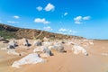 Large sandy beach with stone boulders. Summer landscape