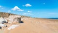 Large sandy beach with stone boulders. Summer travel