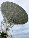 Large satellite dish with cloudy sky for telecommunications and broadcasting in Thailand