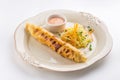 Large sausage roll with carrot cabbage salad isolated on white background