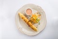 Large sausage roll with carrot cabbage salad on white background