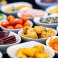 Large savoury snack food selection in porcelain bowls