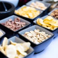 Large savoury snack food selection in porcelain bowls