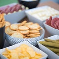 Large savoury snack food selection in porcelain bowls