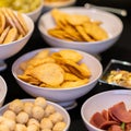 Large savoury snack food selection in porcelain bowls