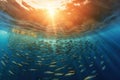 School of fish swimming in circles in ocean with sunlight