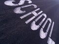 Large SCHOOL sign painted on an urban street