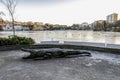 A large sculpture of a crocodile at the shores of a frozen lake in Stavanger city park