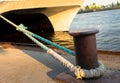 Large sea ship mooring bollard on dock with anchor ropes attached Royalty Free Stock Photo