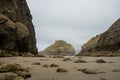 Large Sea Stack Covered In Green Grass Stands Between More Stacks At Low Tide Royalty Free Stock Photo