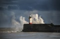 Large sea waves crashing over lighthouse during storm with beaut Royalty Free Stock Photo