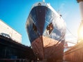 Large seismic or cargo ship in dock on harbor for repair and maintenance, Industrial nautical vessel boat in dockyard Royalty Free Stock Photo