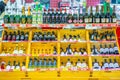 A large selection of alcoholic beverages on the shelves of the supermarket. Text on russian: action, rum, tequila, captain