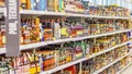 A large selection of alcoholic beverages on the shelves of the supermarket. Text on russian: action, rum, tequila,