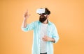 Large selection of compatible apps. Vr concept. Buy vr device. Eye tracking. Testing software. Bearded man yellow Royalty Free Stock Photo