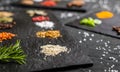 Large selection of different colorful contrast spices and seeds on slate Royalty Free Stock Photo