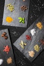 Large selection of different colorful contrast spices and seeds on slate Royalty Free Stock Photo