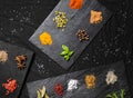 Large selection of different colorful contrast spices and seeds on slate Royalty Free Stock Photo