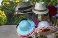 Large selection of hats presented on the shelves of a street shop.