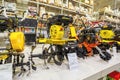 A large selection of motor cultivators for agriculture in a large supermarket Maksidom. Text in Russian: cultivator