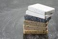 Large selection of stone samples for countertops and floors. Pieces of artificial acrylic stone in a sample box. A set