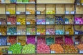 a large selection of sweets lies on a shelf in a store.