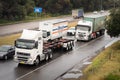 Large semi-trailer trucks with container cargo